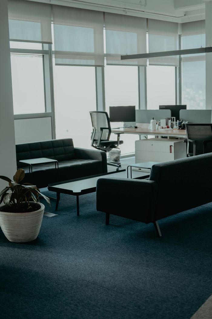 Home A stylish office space with leather sofas and large windows. Perfect for business settings.